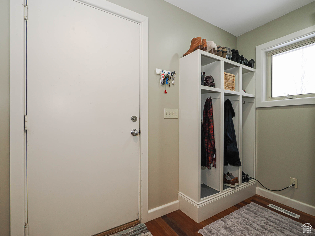 Mudroom featuring visible vents, dark wood-type flooring, and baseboards