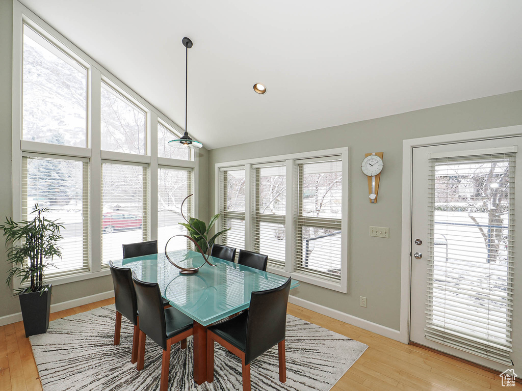 Dining area with recessed lighting, light wood-type flooring, baseboards, and vaulted ceiling