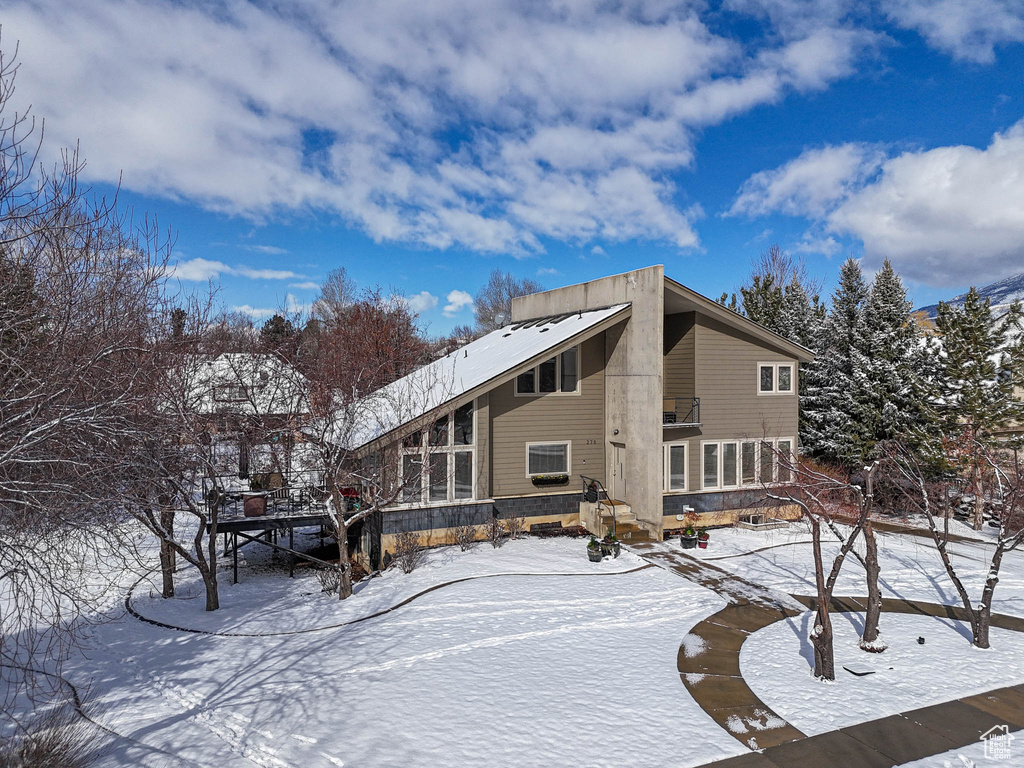 View of snow covered back of property