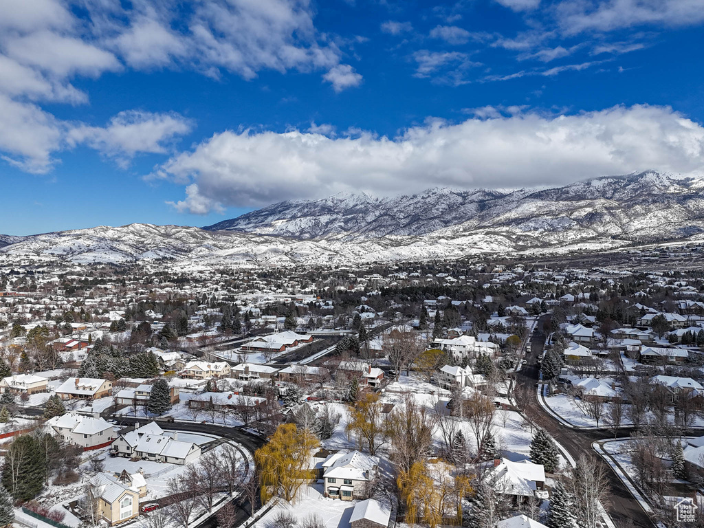 Snowy aerial view with a mountain view and a residential view