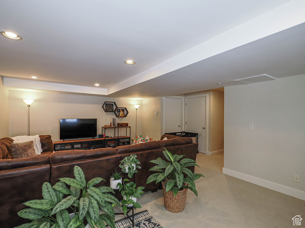 Living room with recessed lighting, baseboards, and light carpet