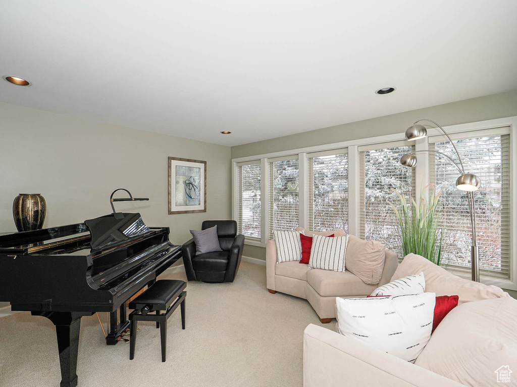 Living area with plenty of natural light, recessed lighting, and light carpet