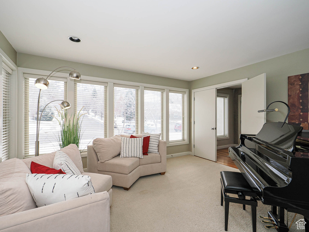 Living area with recessed lighting and light carpet