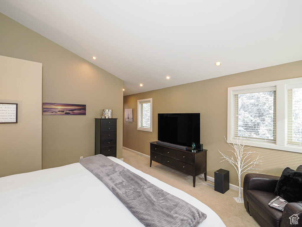 Bedroom featuring recessed lighting, baseboards, lofted ceiling, and light colored carpet