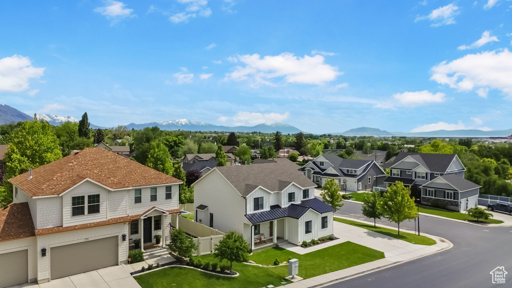 Aerial perspective of suburban area featuring a mountainous background