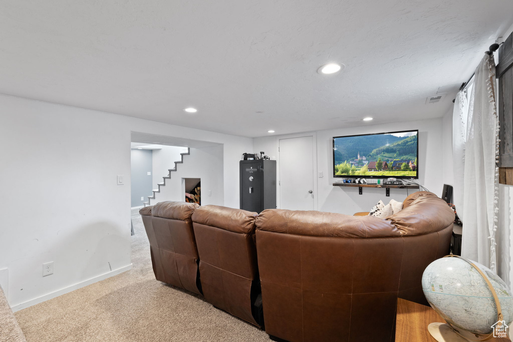 Cinema room with recessed lighting, light colored carpet, and baseboards