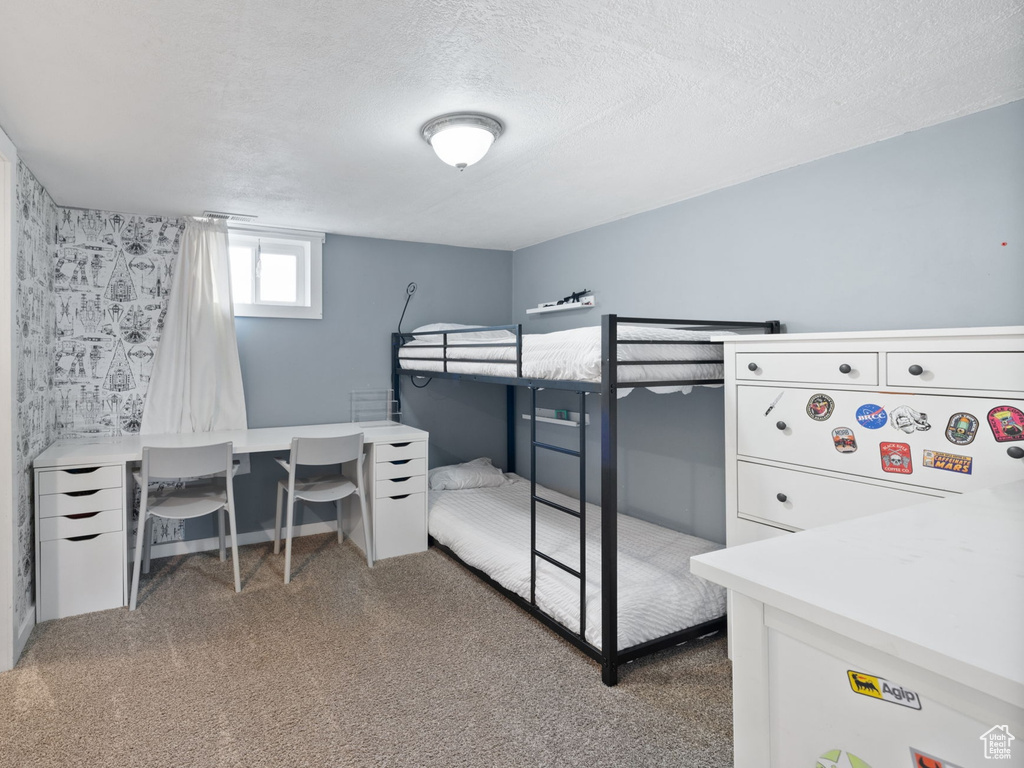 Carpeted bedroom with a closet and a textured ceiling