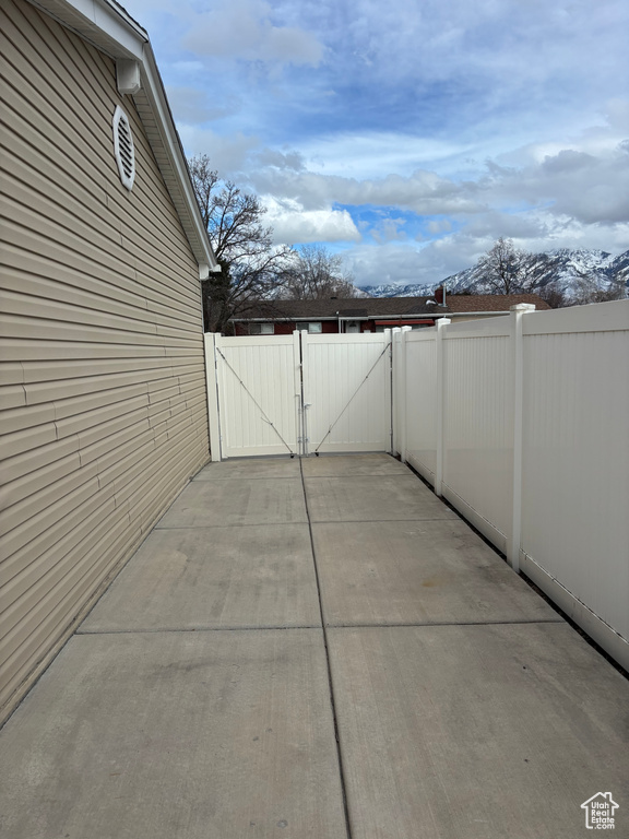 View of patio with a gate and fence