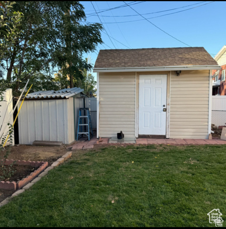 View of shed with a fenced backyard