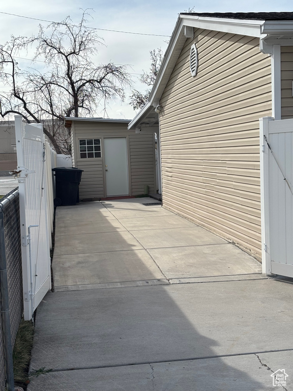 View of side of home with a gate and fence
