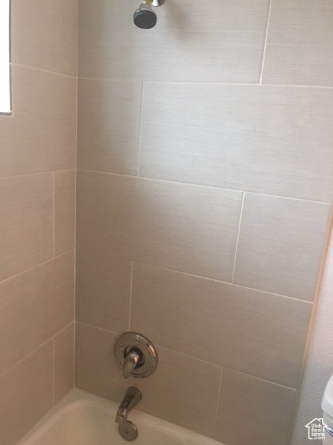 Full bathroom with shower / washtub combination and toilet