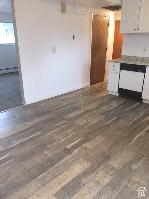 Kitchen featuring a baseboard heating unit, dark wood finished floors, white cabinets, white dishwasher, and baseboards
