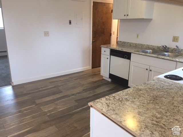 Kitchen featuring a sink, dark wood finished floors, white cabinets, baseboards, and dishwasher