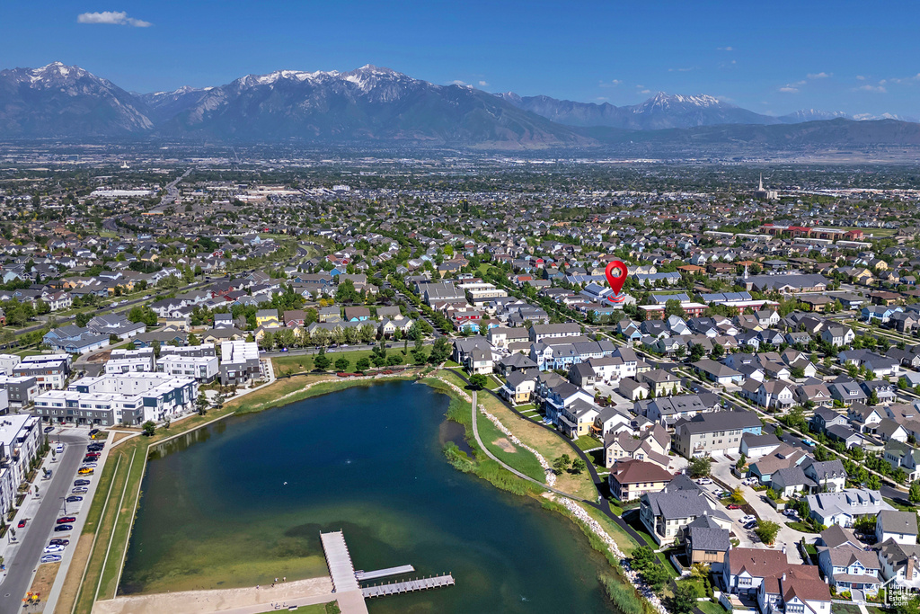 View of property location featuring a water and mountain view and nearby suburban area