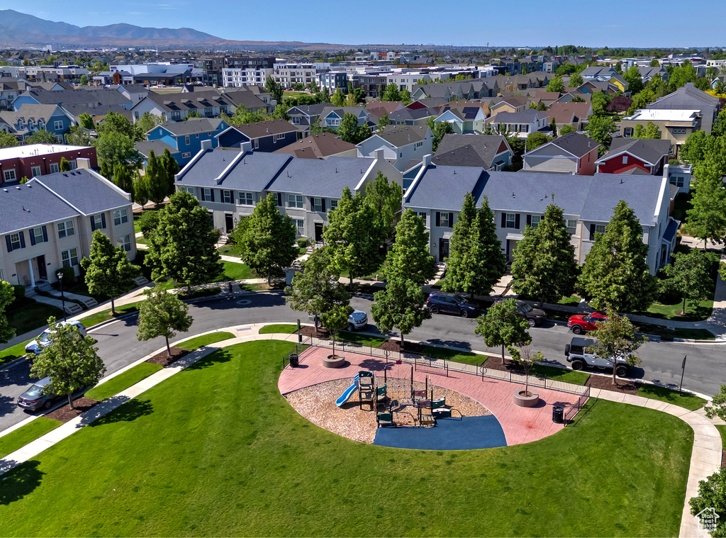 Aerial view of residential area featuring mountains and a park