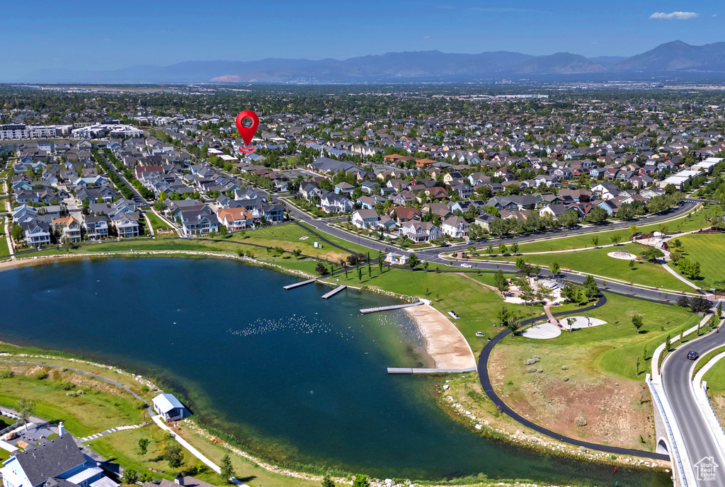 Aerial overview of property\'s location featuring a water and mountain view and nearby suburban area