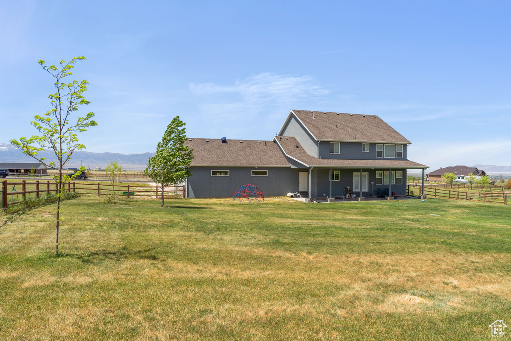Back of property with a rural view