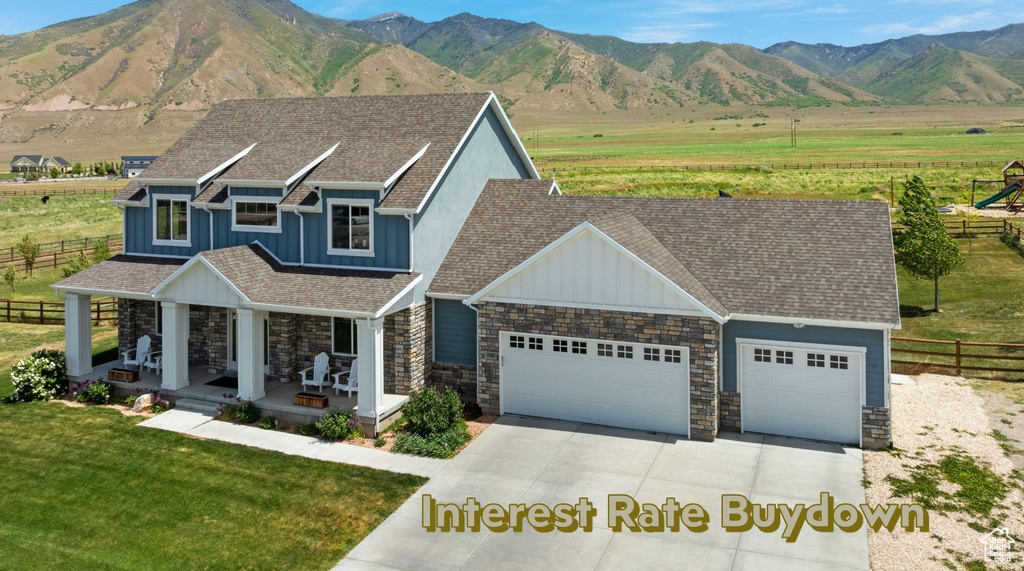View of front of home featuring board and batten siding, stone siding, a garage, and driveway