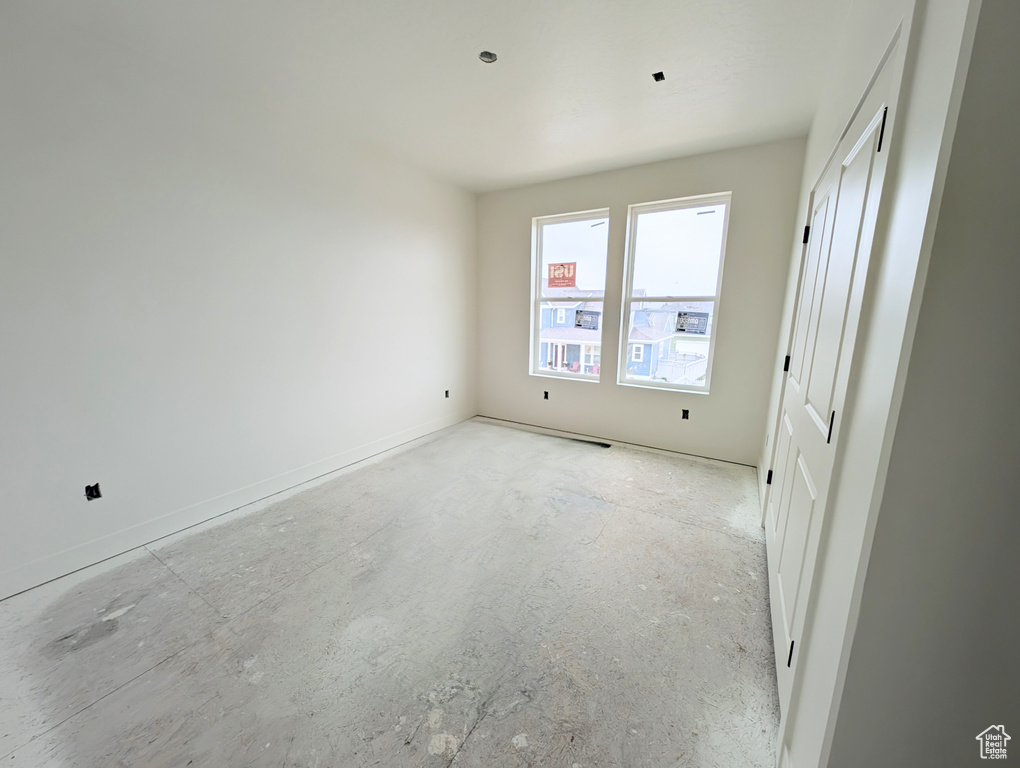 Unfurnished bedroom featuring unfinished concrete floors