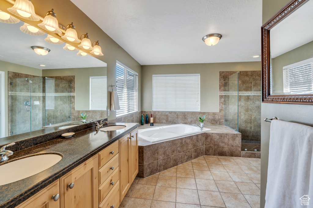 Full bath with a sink, a bath, and a shower stall