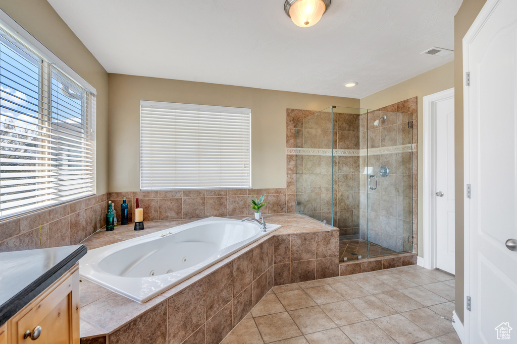 Bathroom with visible vents, tile patterned floors, a stall shower, and a tub with jets