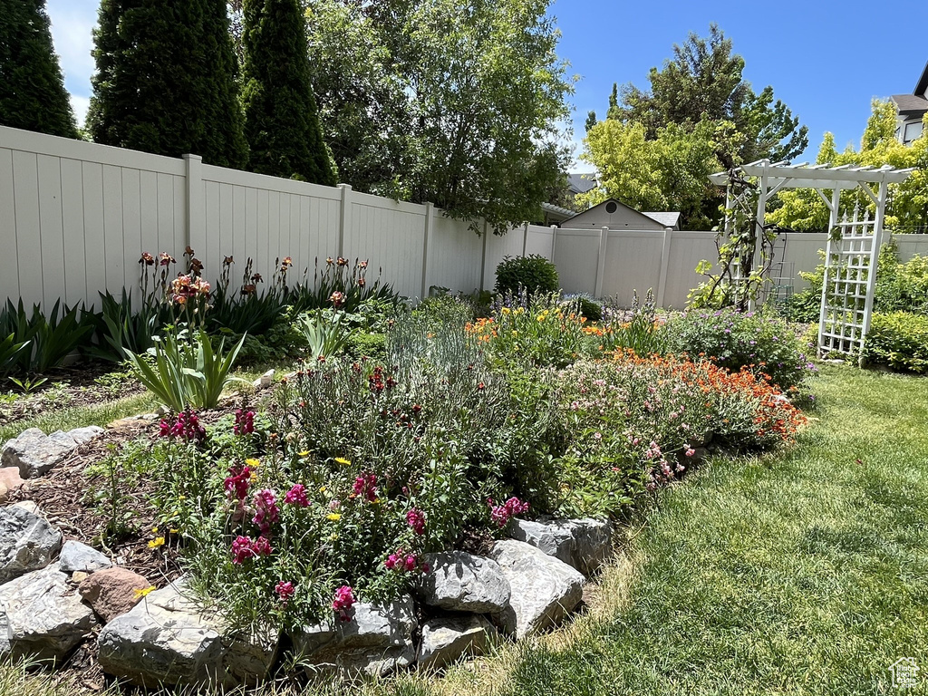View of yard with a pergola and a fenced backyard