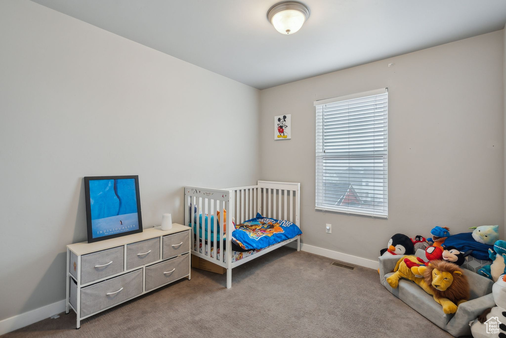 Bedroom with carpet flooring, visible vents, and baseboards