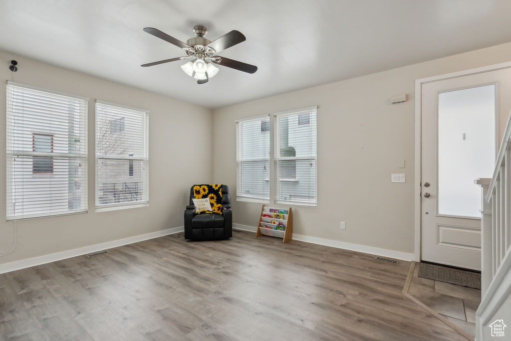 Interior space with visible vents, wood finished floors, baseboards, and ceiling fan