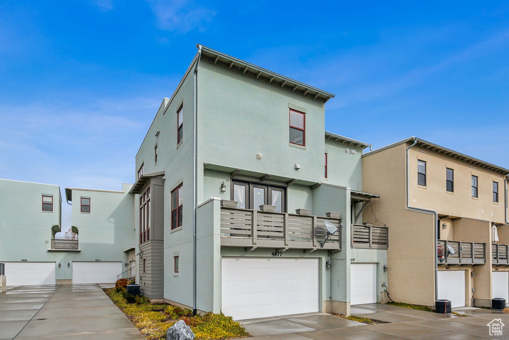 Back of house featuring stucco siding