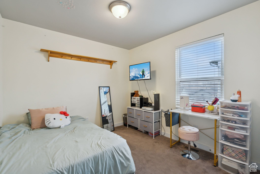 Carpeted bedroom featuring baseboards