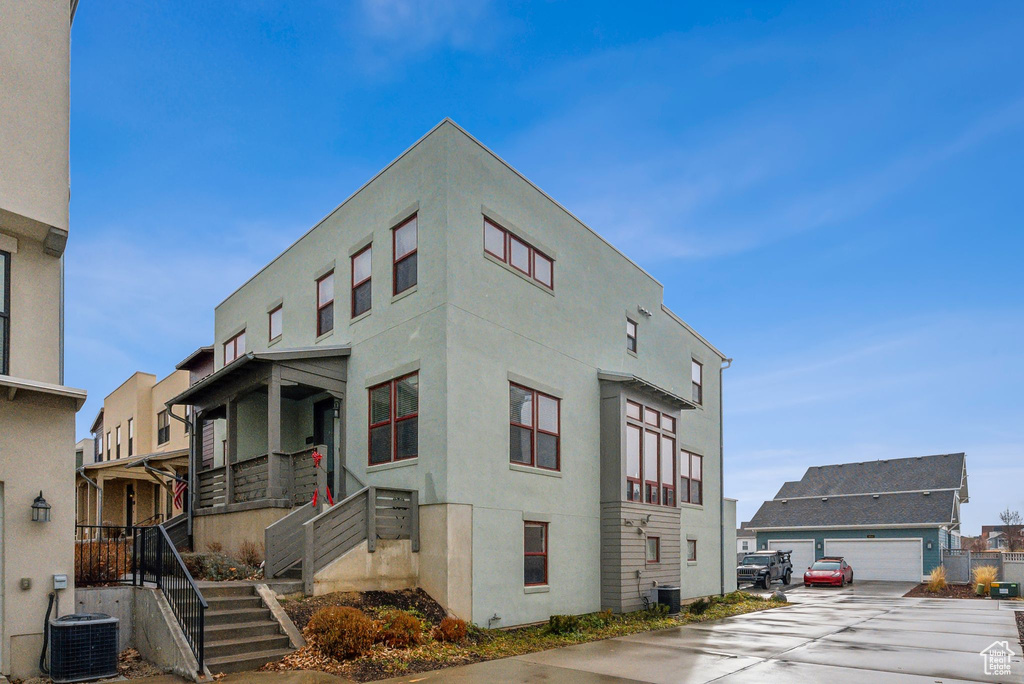 View of building exterior with stairway and cooling unit