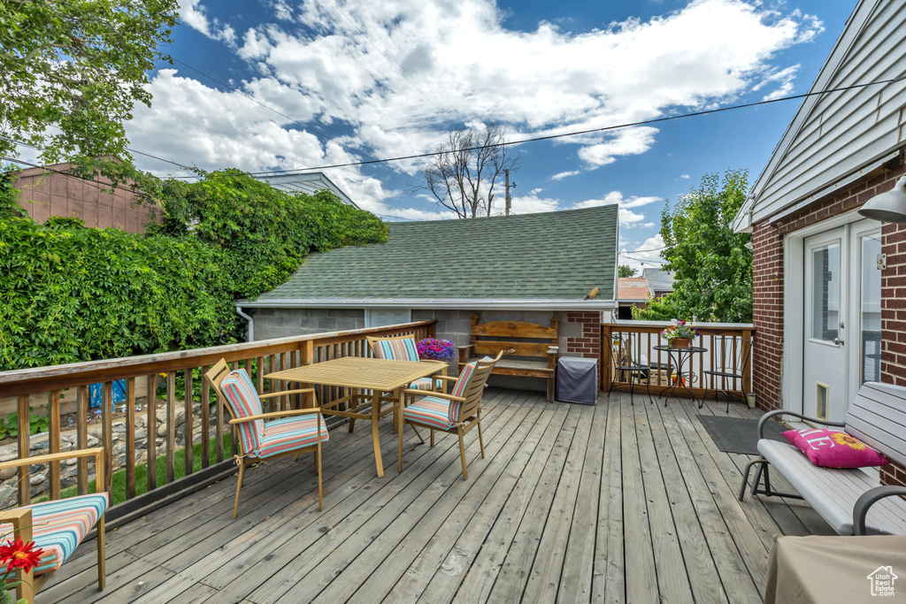 Wooden terrace featuring outdoor dining space
