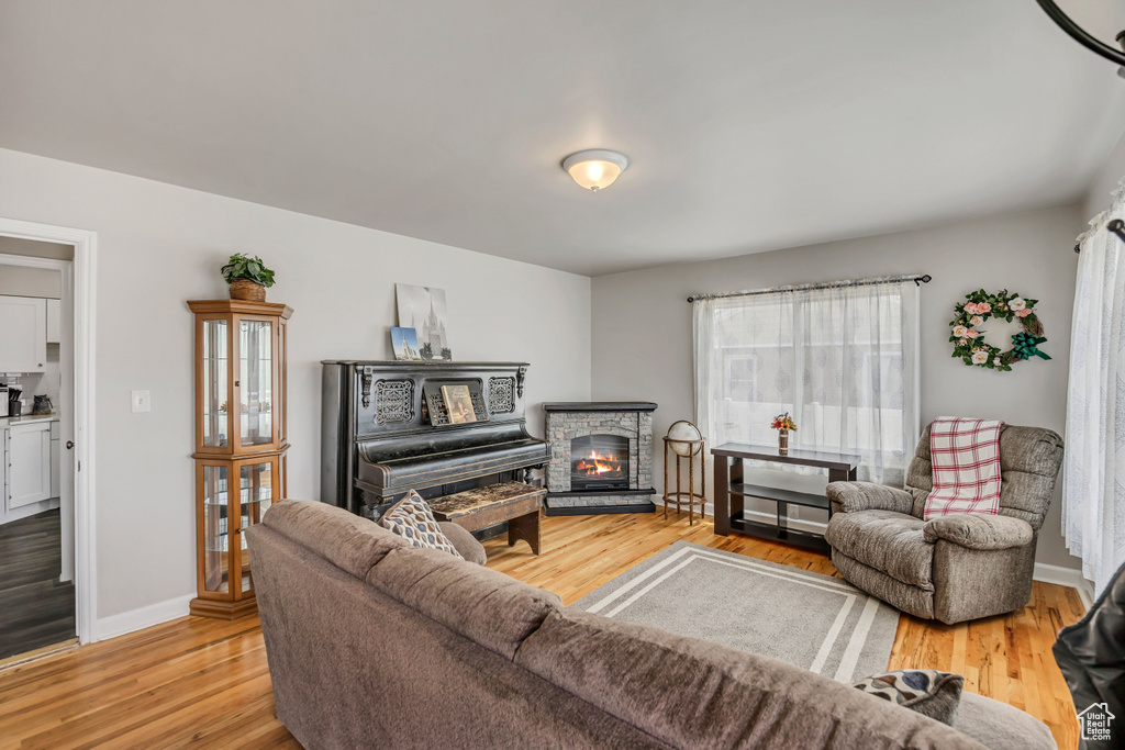 Living room with light wood-style floors and a fireplace