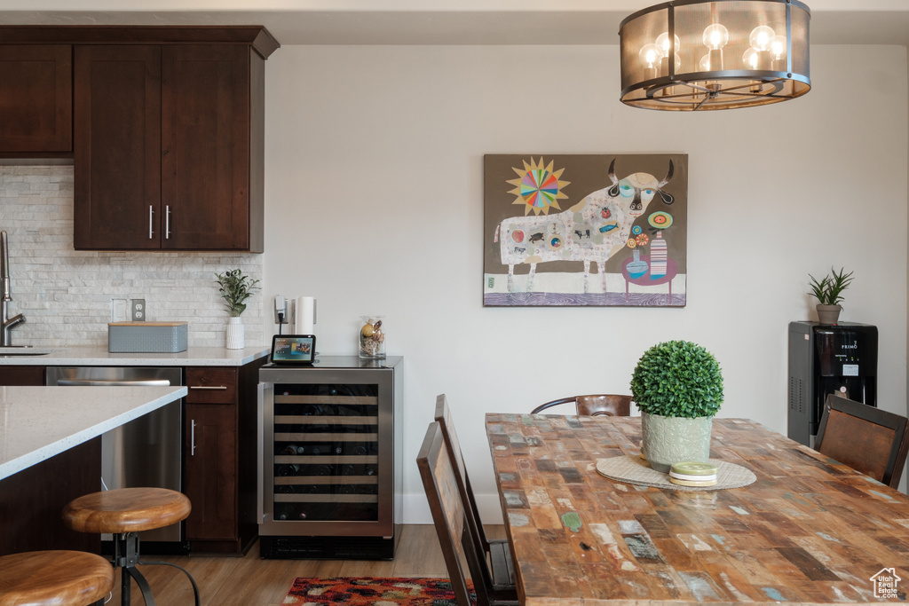 Dining room featuring beverage cooler and wood finished floors