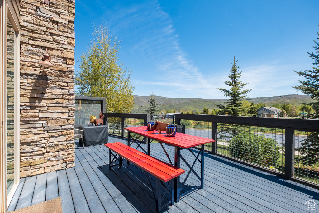 Deck featuring a mountain view and outdoor dining space