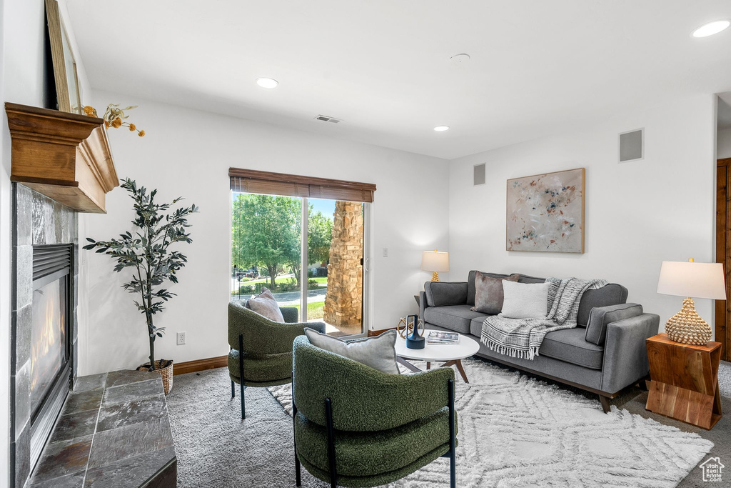 Living room featuring a tile fireplace and recessed lighting