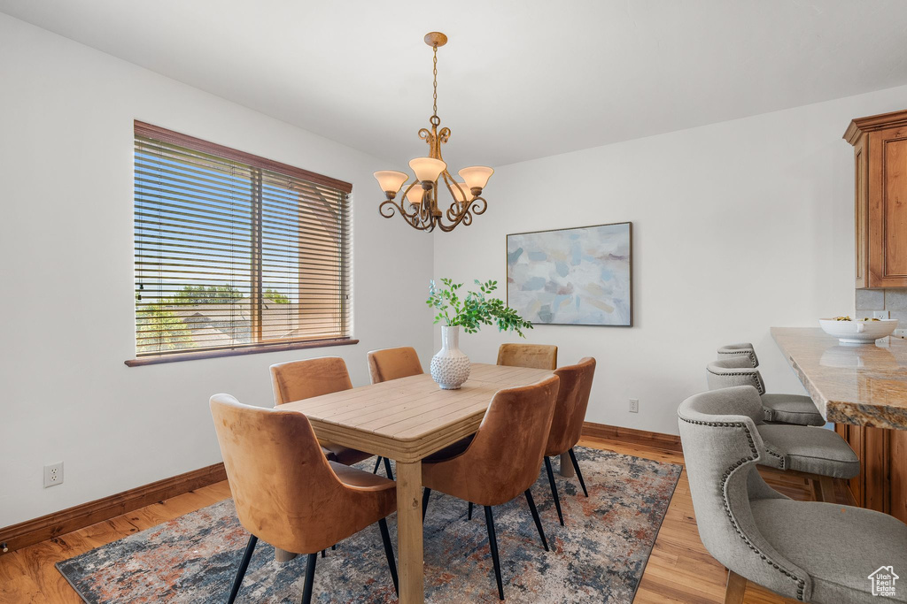 Dining space featuring a chandelier and light wood finished floors