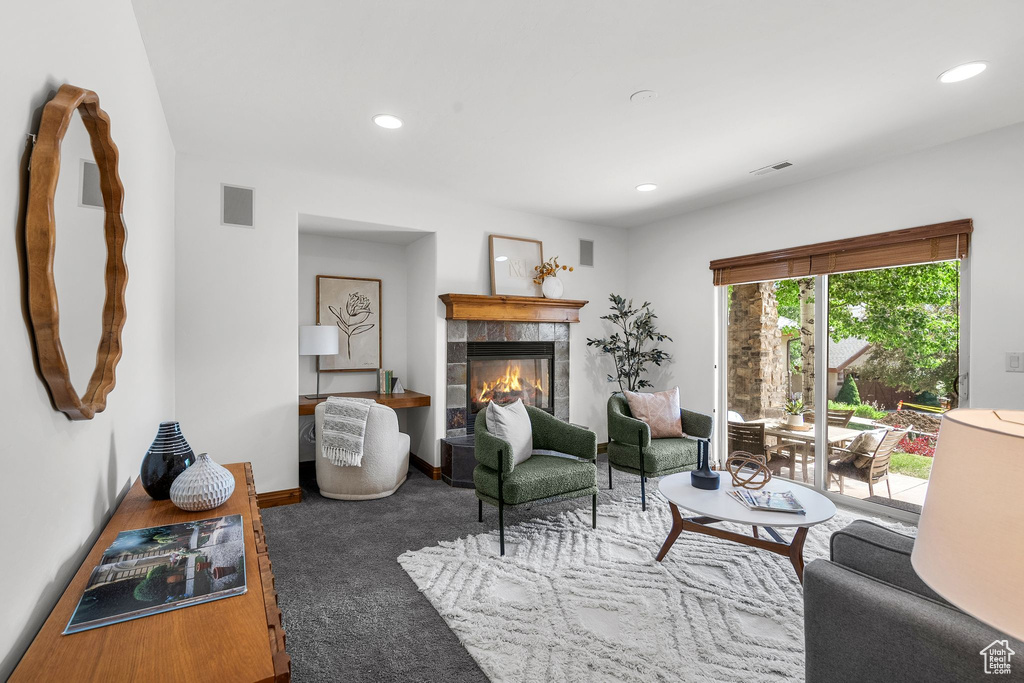 Living room with recessed lighting and a tile fireplace