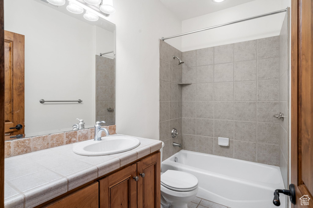 Bathroom featuring vanity and shower / bath combination