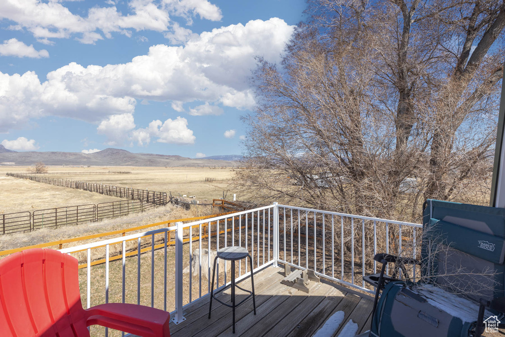 Wooden deck featuring a mountain view and a rural view