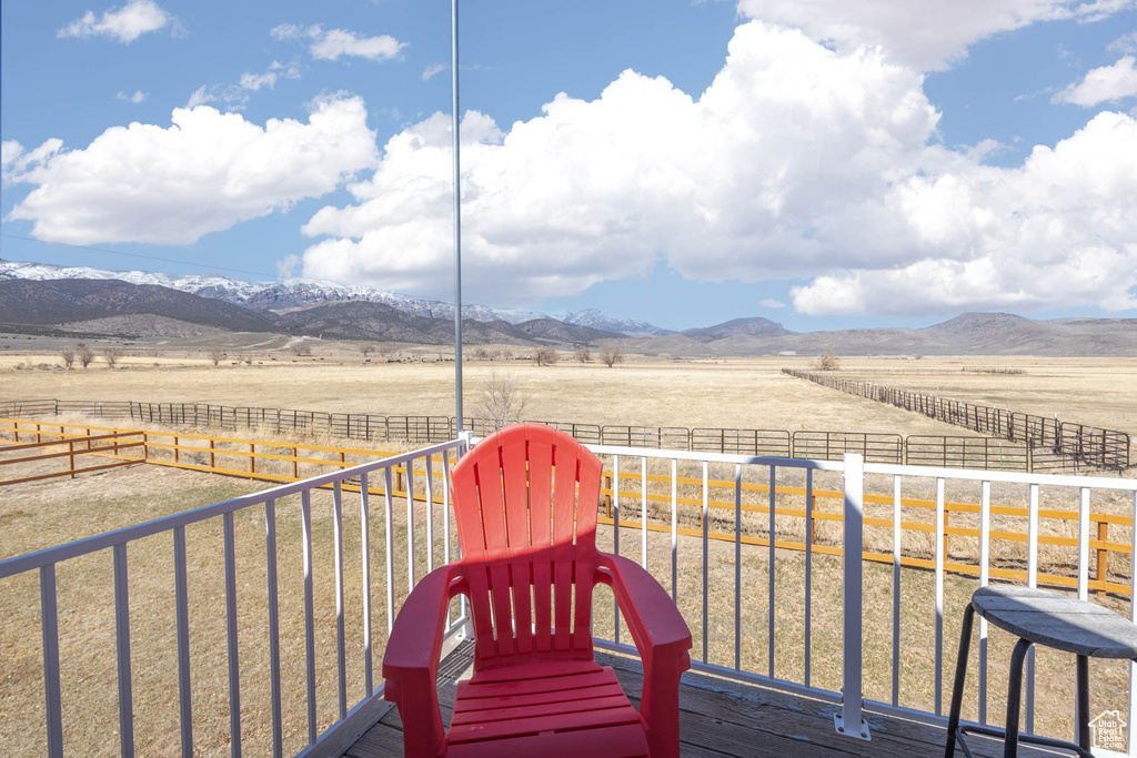 Deck featuring a mountain view, a rural view, and fence