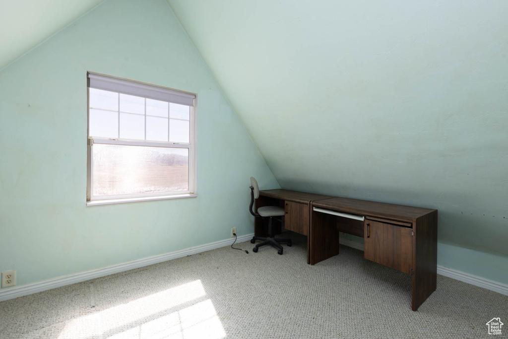 Office area featuring lofted ceiling, carpet flooring, and baseboards