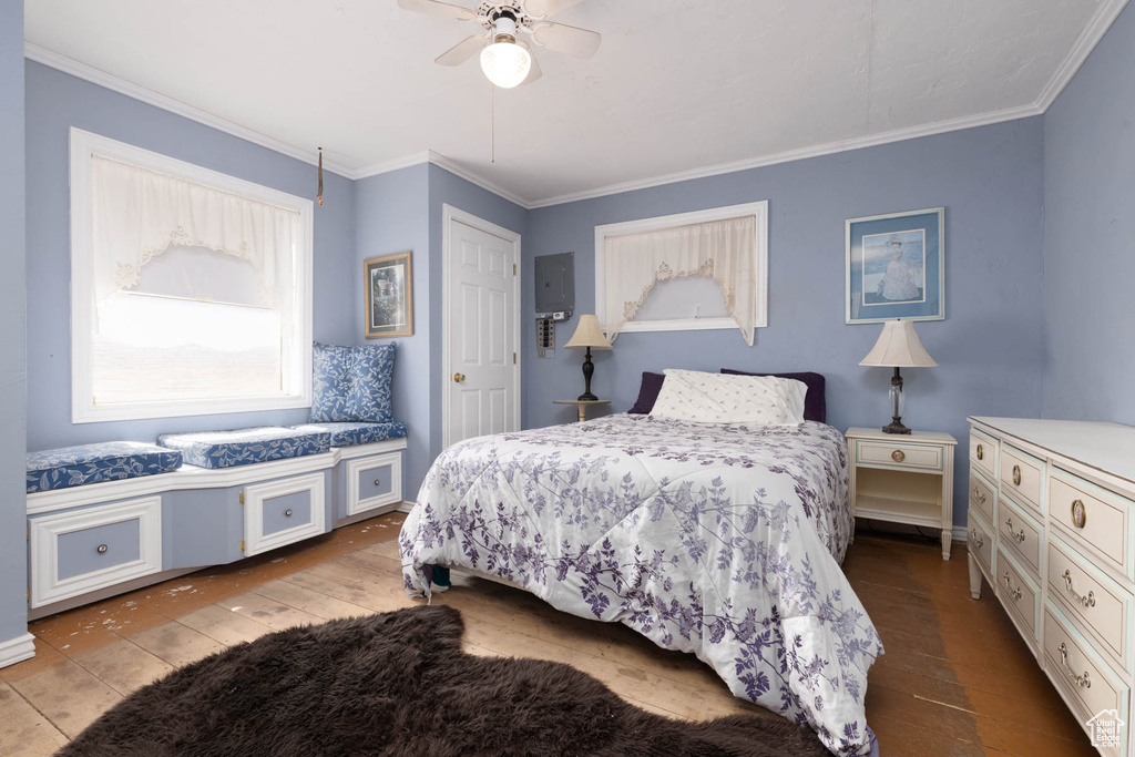 Bedroom featuring wood finished floors, a ceiling fan, and ornamental molding