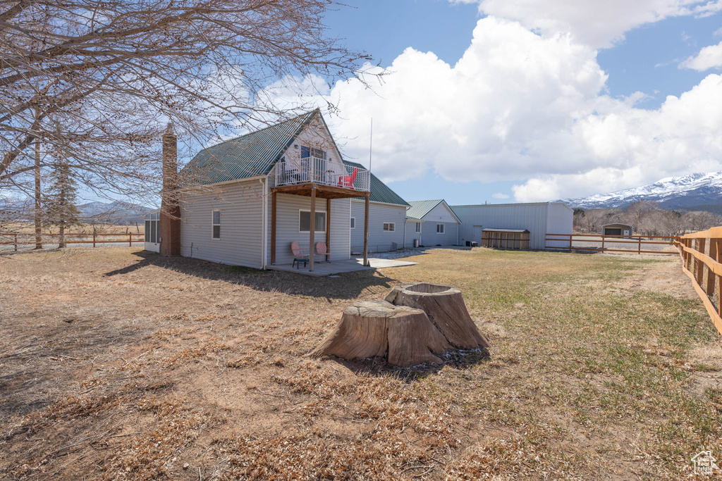 Back of house with a patio, a yard, a fenced backyard, and a chimney