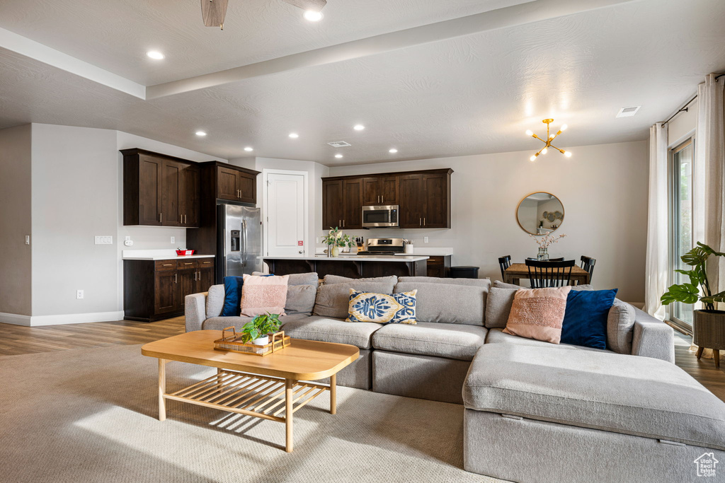 Living room with recessed lighting, baseboards, light wood-style flooring, and ceiling fan