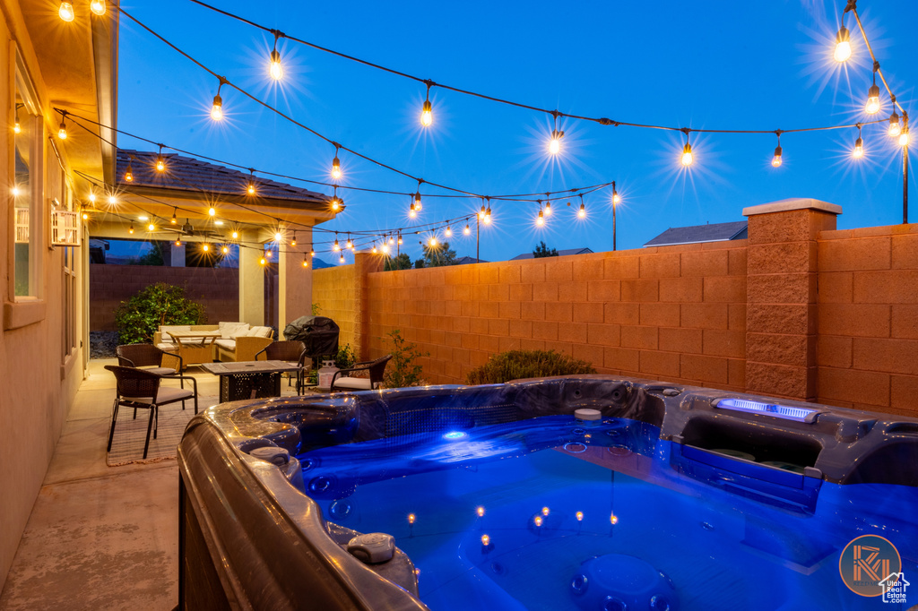 View of swimming pool with a patio area, a fenced backyard, and a hot tub