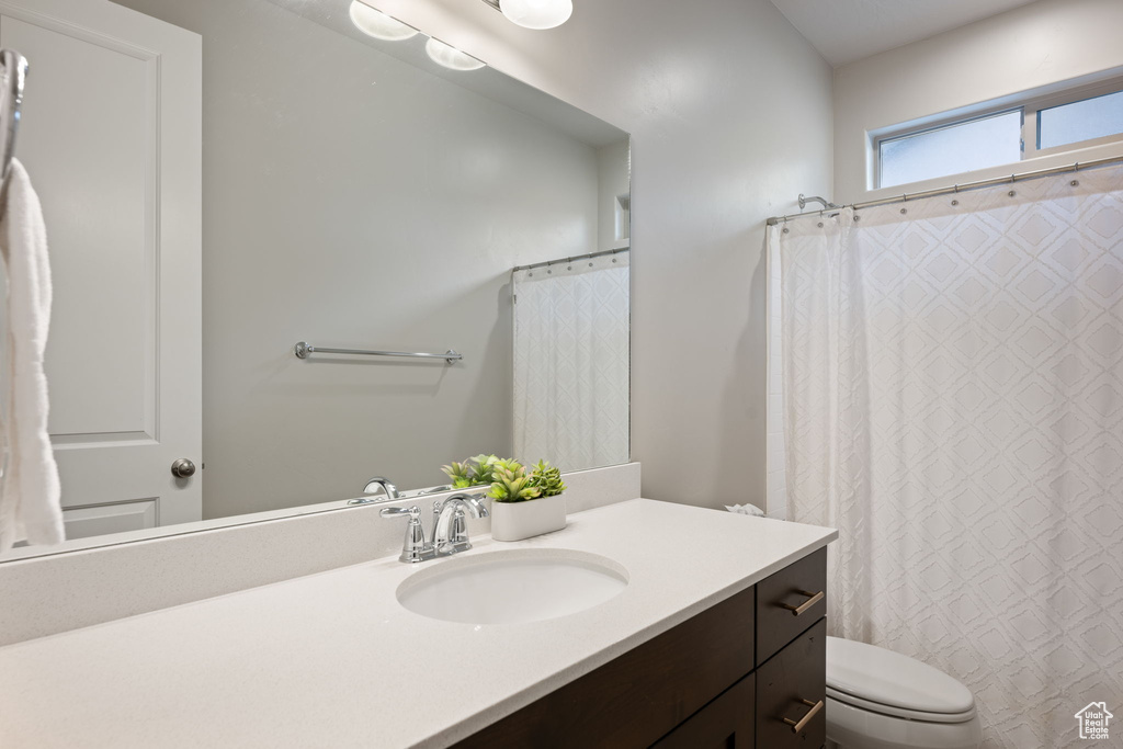 Full bathroom with vanity and toilet