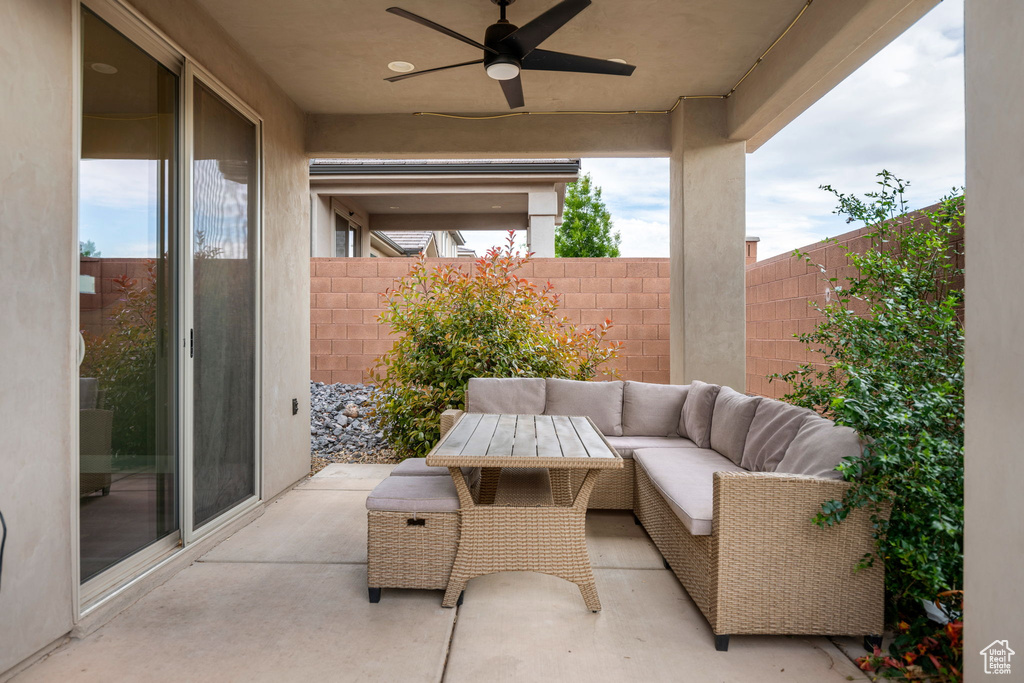 View of patio featuring an outdoor hangout area, a fenced backyard, and a ceiling fan
