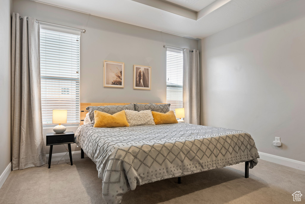 Bedroom featuring baseboards and light carpet