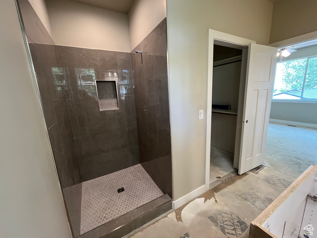 Full bathroom featuring walk in shower and baseboards
